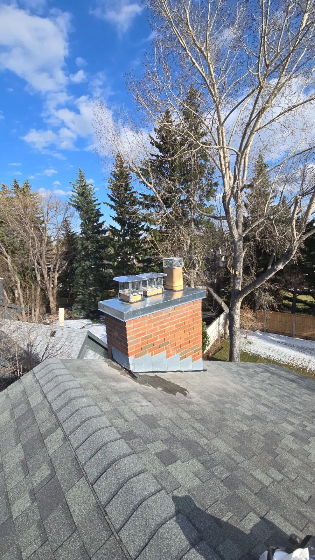 Completed reinforced concrete chimney crown replacement on a residential brick chimney in Calgary