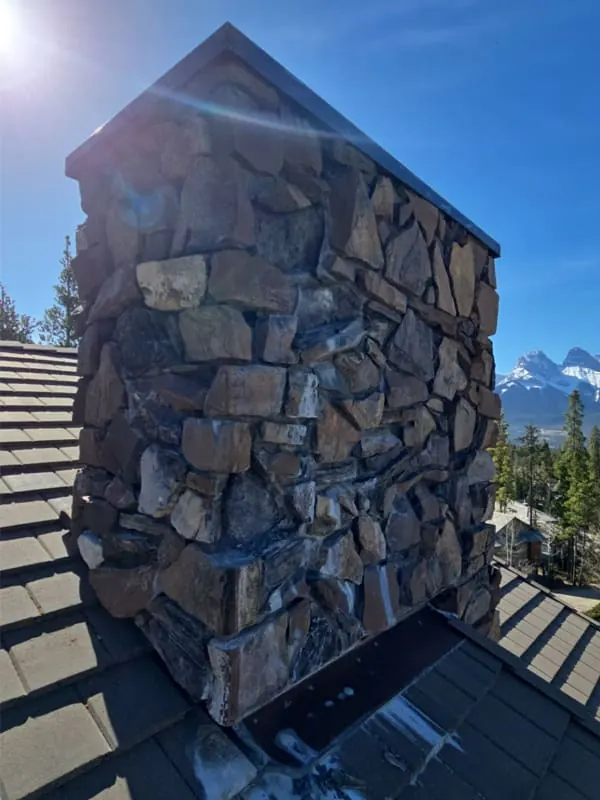 Natural Stone Chimney in Canmore completed by Martini Stone Masonry in Calgary and surrounding Alberta communities.