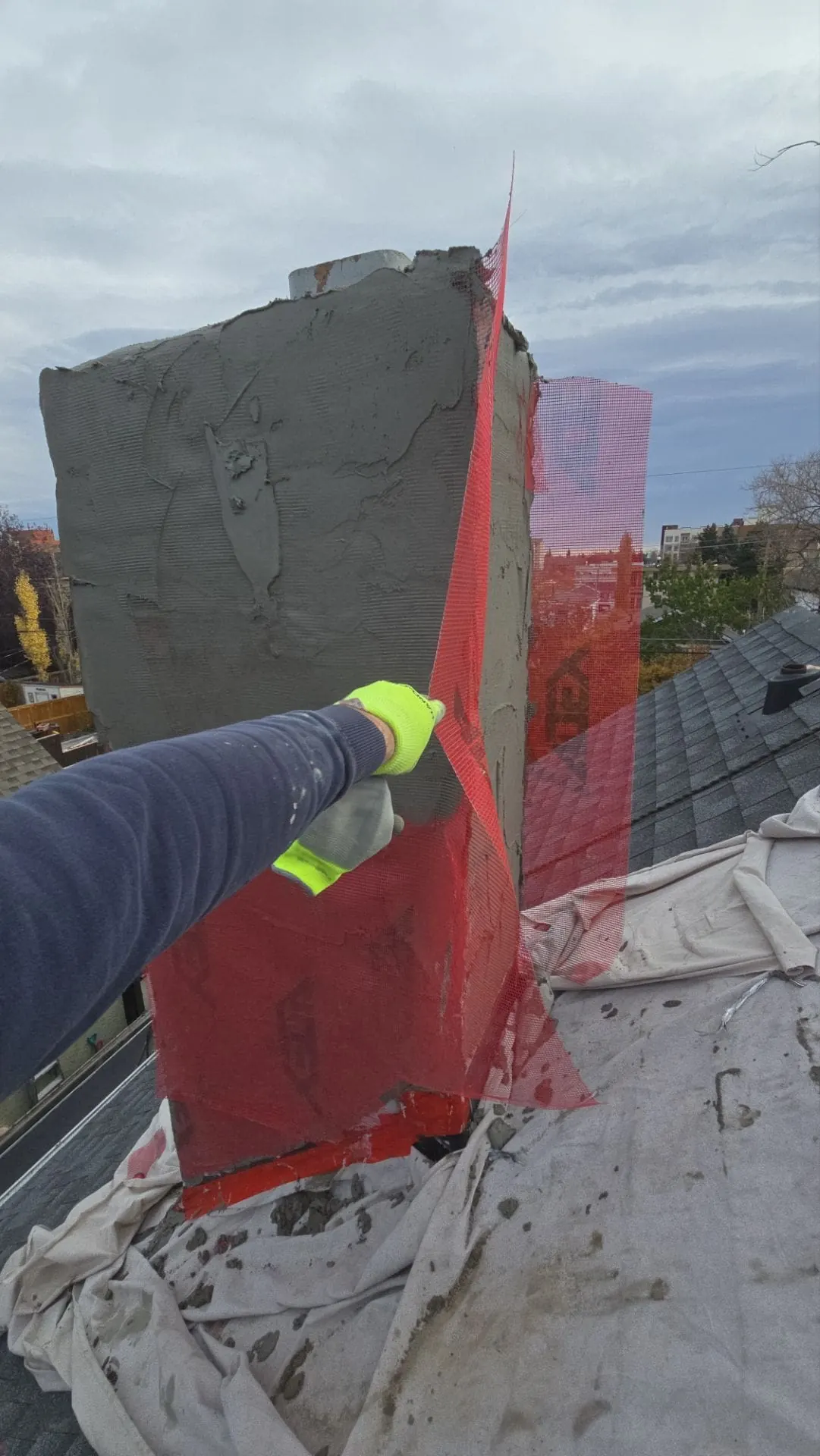 New stucco applied to a chimney at 1411 1A St NW, Calgary