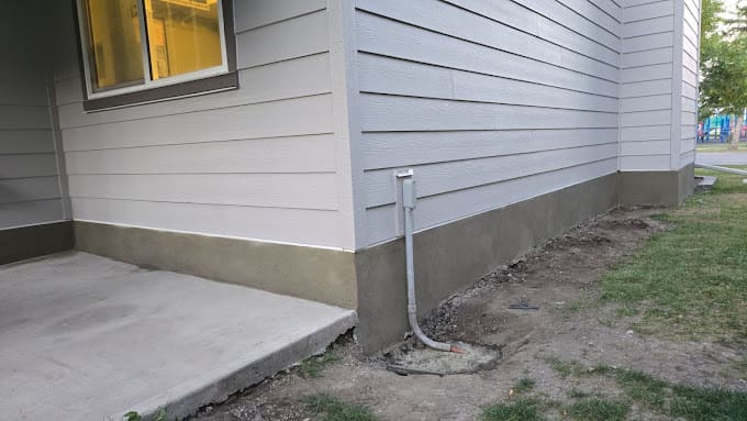 Freshly applied parging on a residential foundation in Calgary