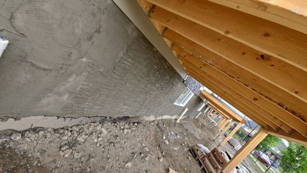 Wavy texturing to parging coat under deck area