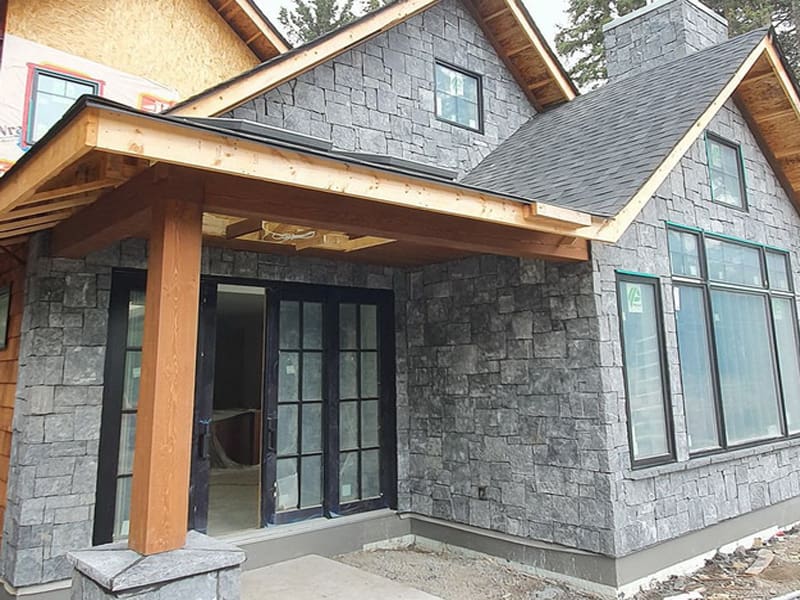 Luxury natural stone residence with custom exterior masonry in Canmore